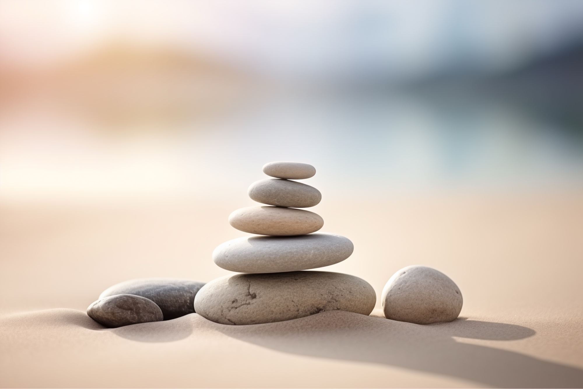 Stacked zen stones balanced on sand